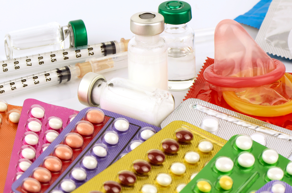 A photo of different contraceptives over a white background.