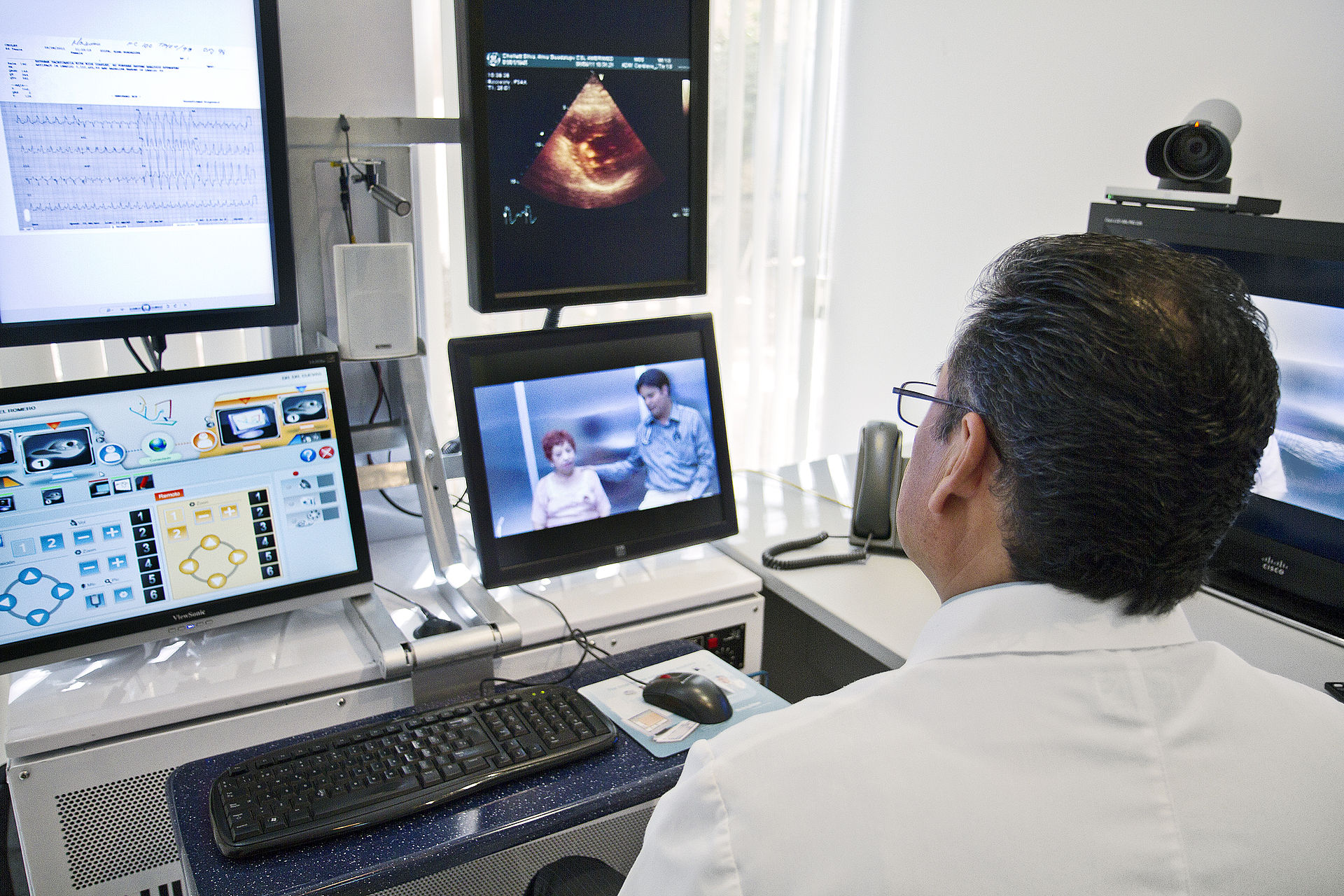 A doctor engages in a teleconsult with a patient who lives far away.