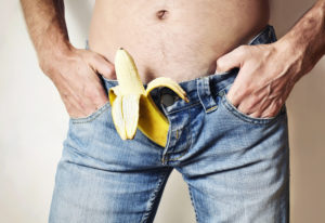 Shirtless man with banana in his jeans