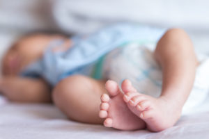 Baby lying on bed